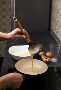 Cropped hand of woman preparing food