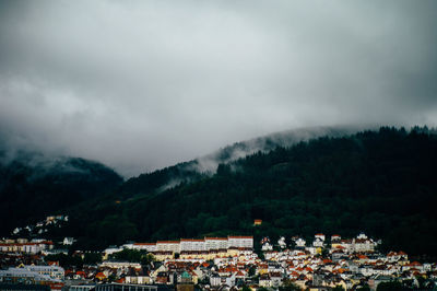 Town by mountains against sky