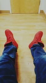 Low section of man sitting on hardwood floor