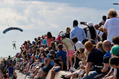 Group of people sitting against sky