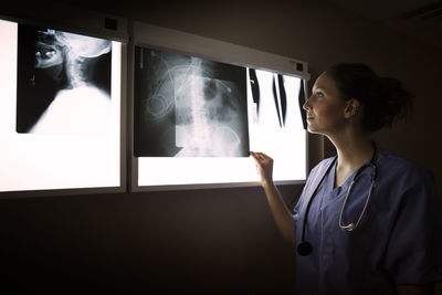 Woman looking at x-ray on diagnostic medical tool