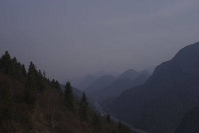 Scenic view of silhouette mountains against sky at dusk