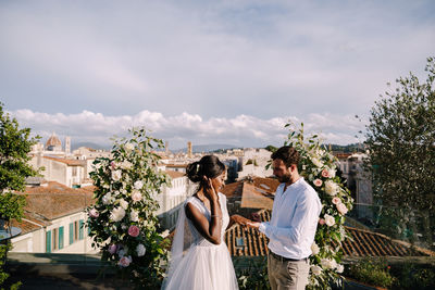 Couple kissing against plants