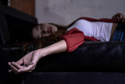 Woman lying down on bed at home