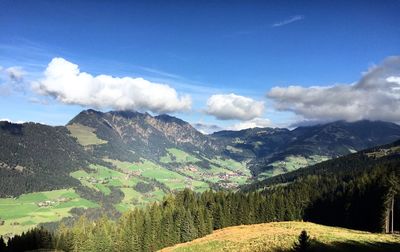 Scenic view of mountains against blue sky