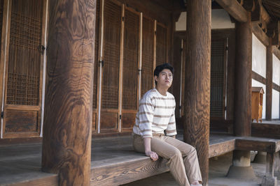 Portrait of woman sitting on wood