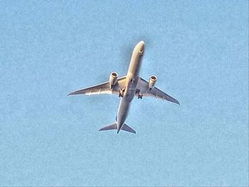 Low angle view of airplane flying in sky