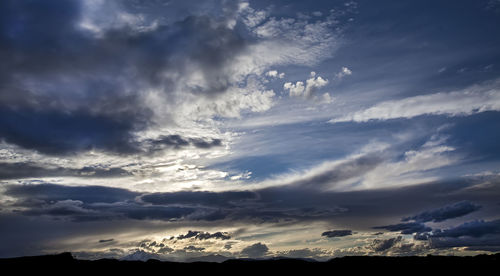 Scenic view of mountains against cloudy sky