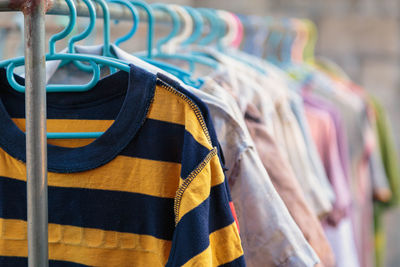 Close-up of clothes hanging on rack at store