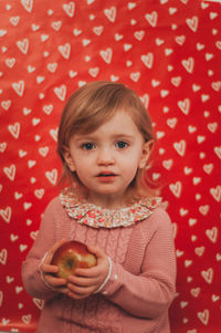Cute baby girl with an apple 