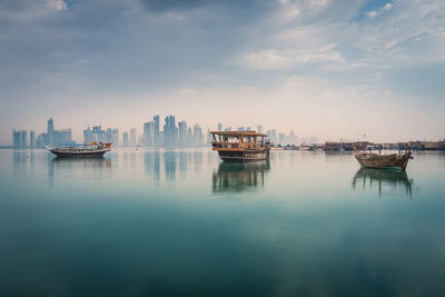 Boats in sea against sky