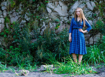 Portrait of young woman standing in forest