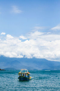 Boat sailing in sea against sky