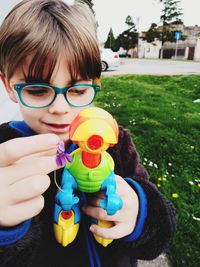 Cute boy playing with toy in yard