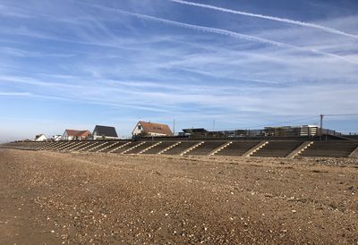 Houses on field against sky