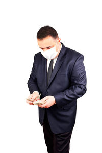 Young man holding camera against white background