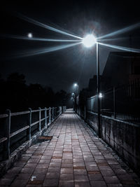 Rear view of man walking on footbridge