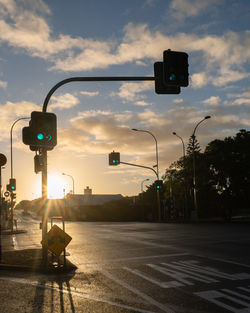 View of road signal against cloudy sky