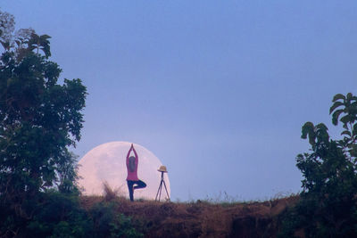 View of people on field against clear sky