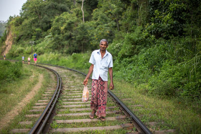 Full length portrait of man on railroad track