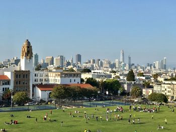 People in city against clear sky