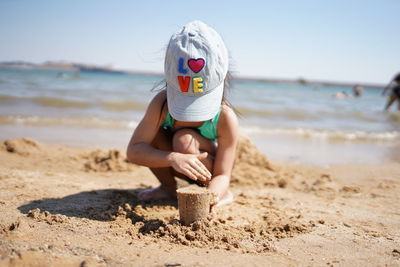 Full length of woman on beach against sea