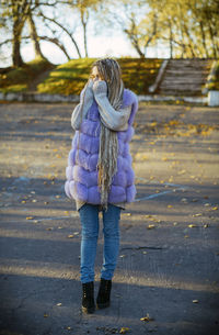 Rear view of woman standing outdoors