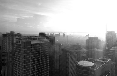 Cityscape against sky during foggy weather