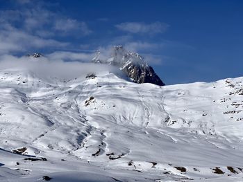 Scenic view of snow covered mountain against sky