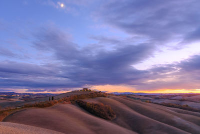 Road amidst landscape against sky during sunset