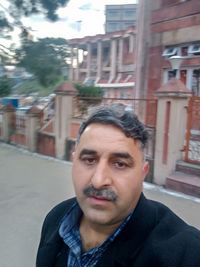 Portrait of man on street in city