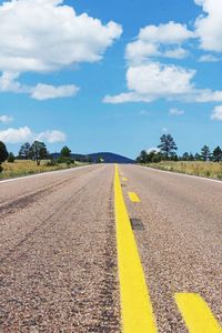 Empty road against cloudy sky