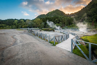 Scenic view of hot spring against sky