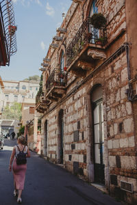 Rear view of woman walking on street in city