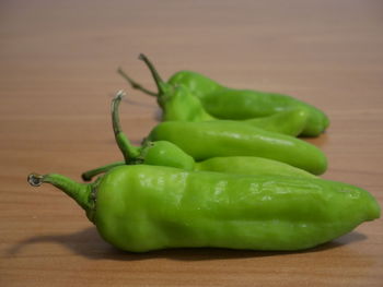 Close-up of green chili peppers on table