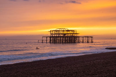 Scenic view of sea against orange sky