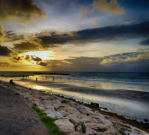 Scenic view of beach against sky during sunset