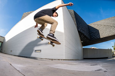 Low angle view of man standing on roof