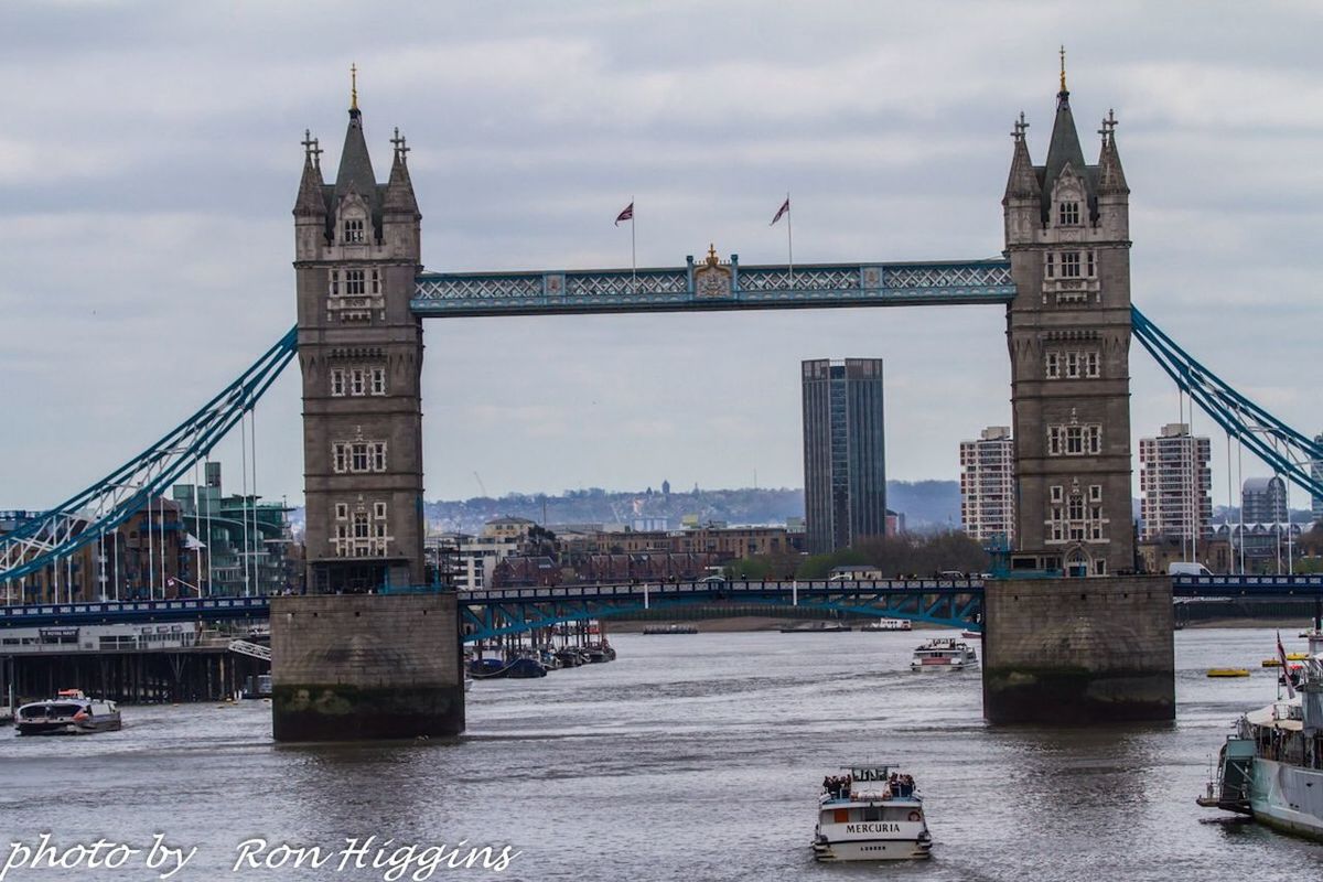 architecture, built structure, building exterior, sky, city, water, tower, travel destinations, famous place, cloud - sky, river, incidental people, capital cities, day, tall - high, tourism, outdoors, travel, international landmark, city life