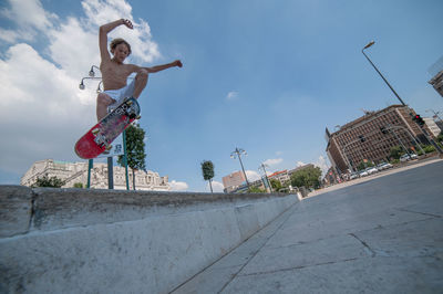 Low angle view of man skateboarding on street