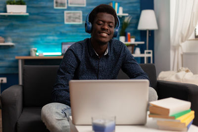 Smiling man listening music at home