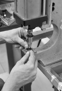 Close-up of man working on metal