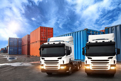 View of truck on road against cloudy sky