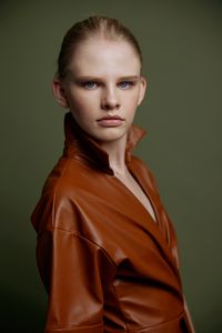 Portrait of young woman against gray background