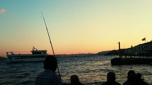 Boats in harbor at sunset