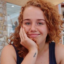 Close-up portrait of smiling young woman