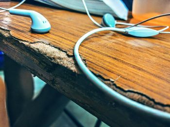 Close-up of earphone on wooden table