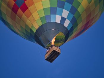 Low angle view of hot air balloon against blue sky