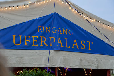 Low angle view of tent against blue sky