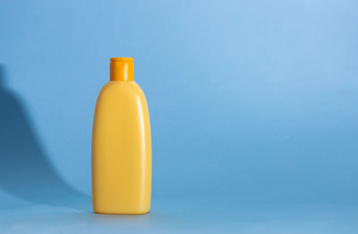 Close-up of bottle against blue background